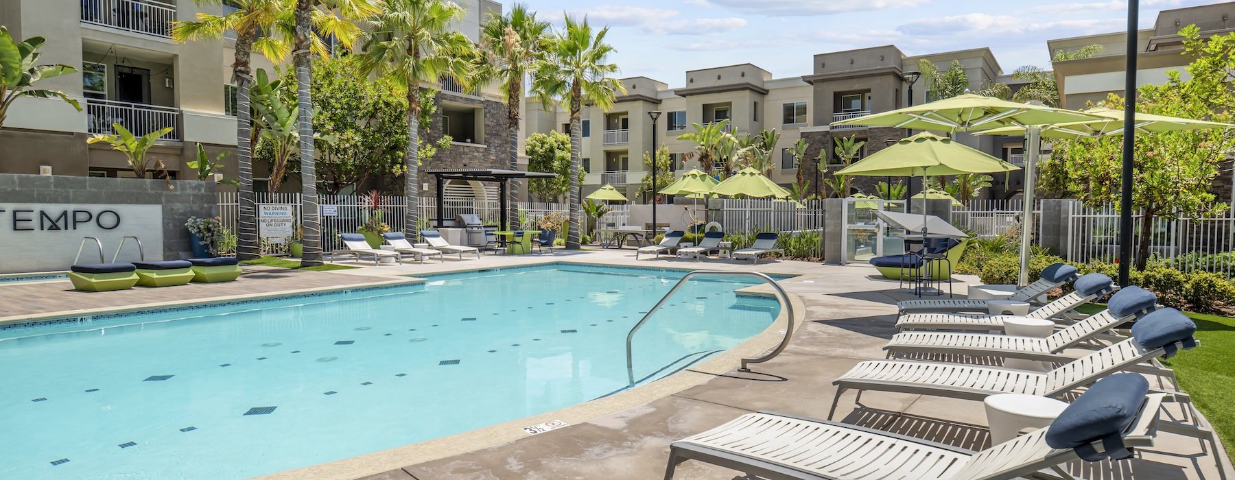 a swimming pool with lounge chairs
