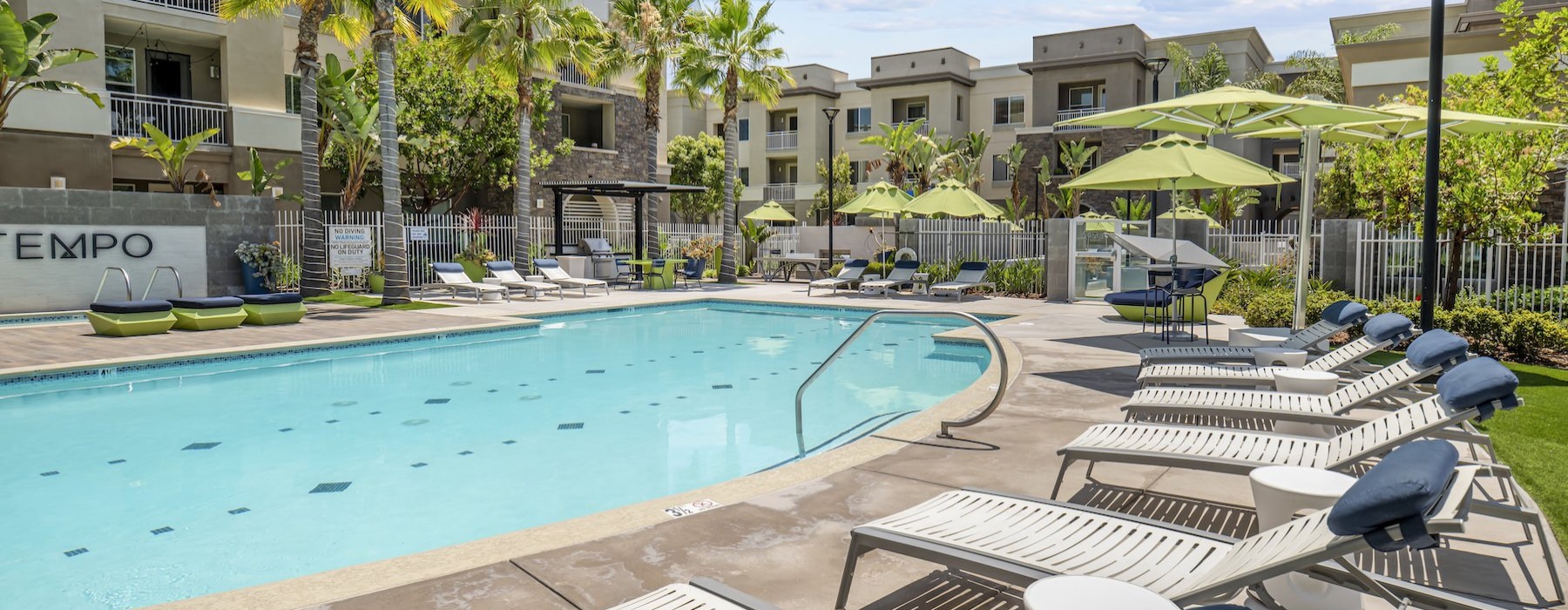 a swimming pool with lounge chairs