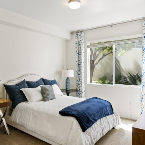 a bedroom with a bed and a desk