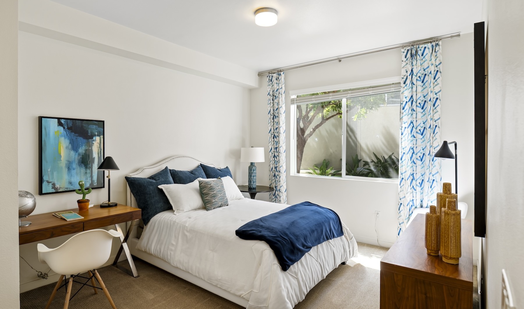 a bedroom with a bed, desk and a chair