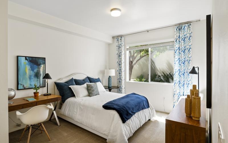 a bedroom with a bed and a desk